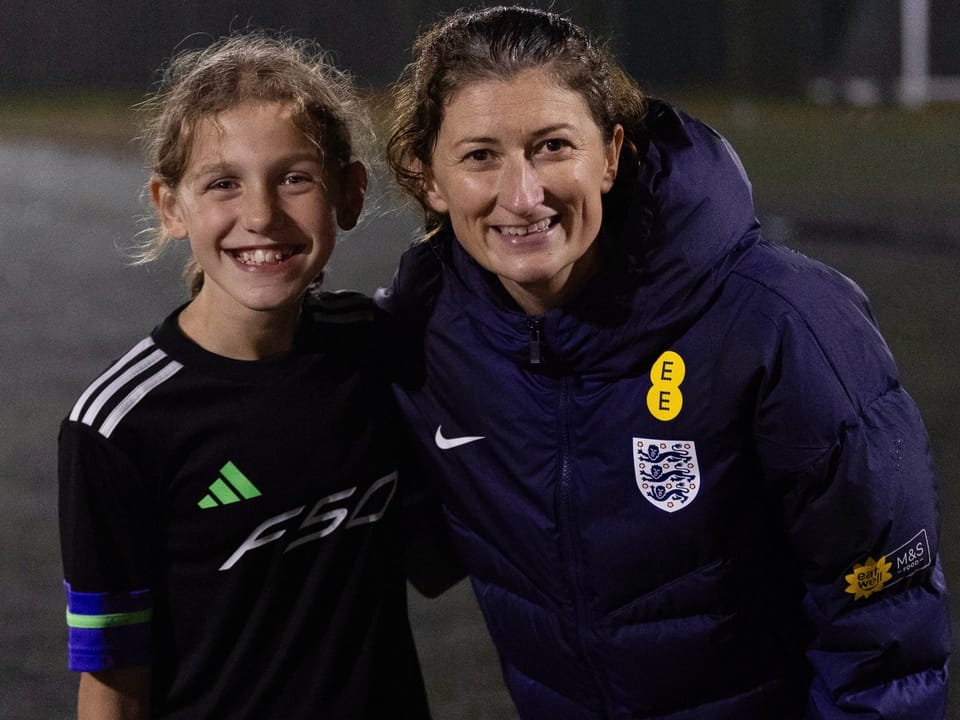 Coach guiding a young player
